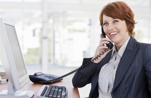 Happy young businesswoman talking on phone